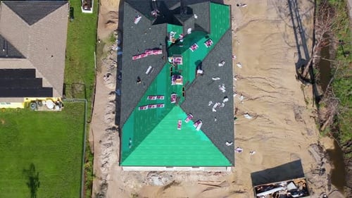 Installation of Asphalt Shingles on Modern Home Rooftop Construction Work in Progress Real Estate