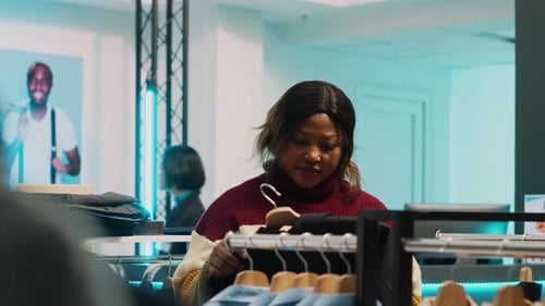 Store Assistant Helping Woman to Choose Trendy Clothes