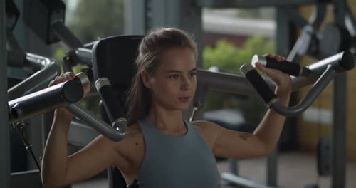 Sporty Young Woman Training Back Muscles in Gym Female Hands Taking Bodybuilding Dumbbells in Gym