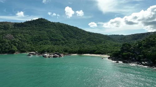 Secluded Tropical Cove: Lush Green Mountains and Turquoise Waters