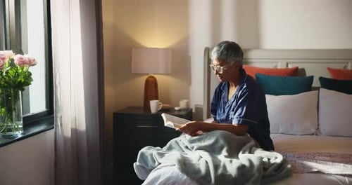 Woman Relaxing in Bedroom Reading a Book