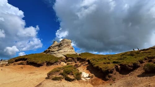 Whimsical rock at the mountain top. Hiking in the Bucegi Mountains of the Southern Carpathians