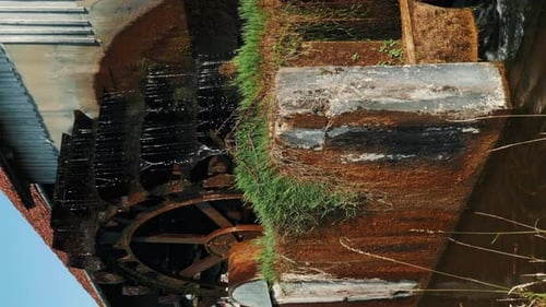 Rotating water mill. Old wooden water mill