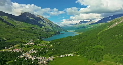 Drone Flies Over Green Picturesque Valley with Mountains in the Background High Mountains Famous
