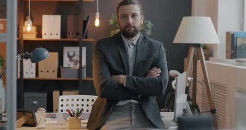 Confident Man with Beard Poses in Office