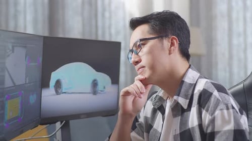 Man Working on Car Design at Computer