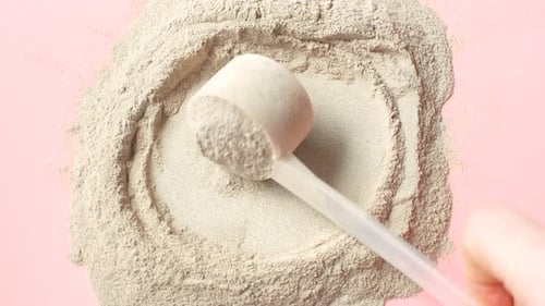 Powder and Scoop on Pink Background