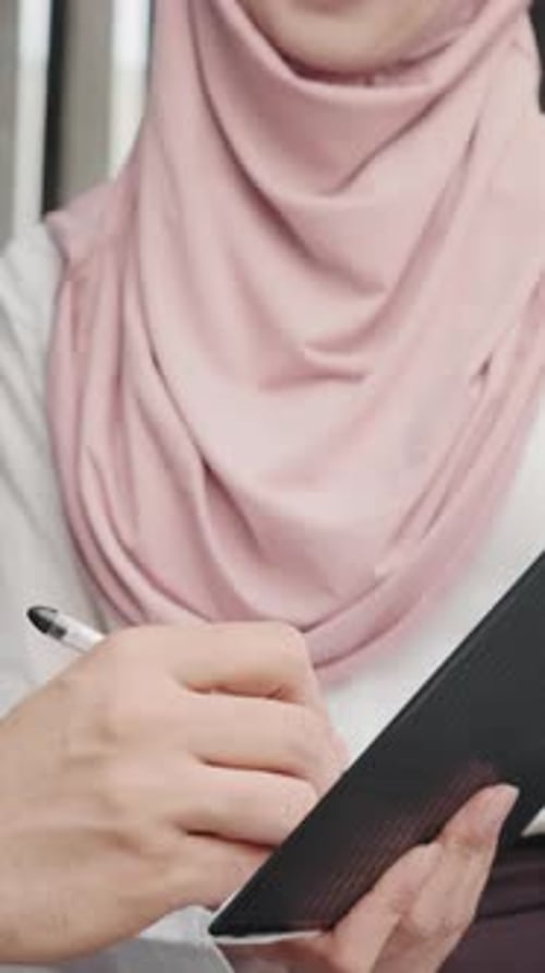 Woman Signs Document in Urban Environment