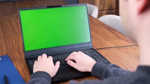 man working green screen laptop