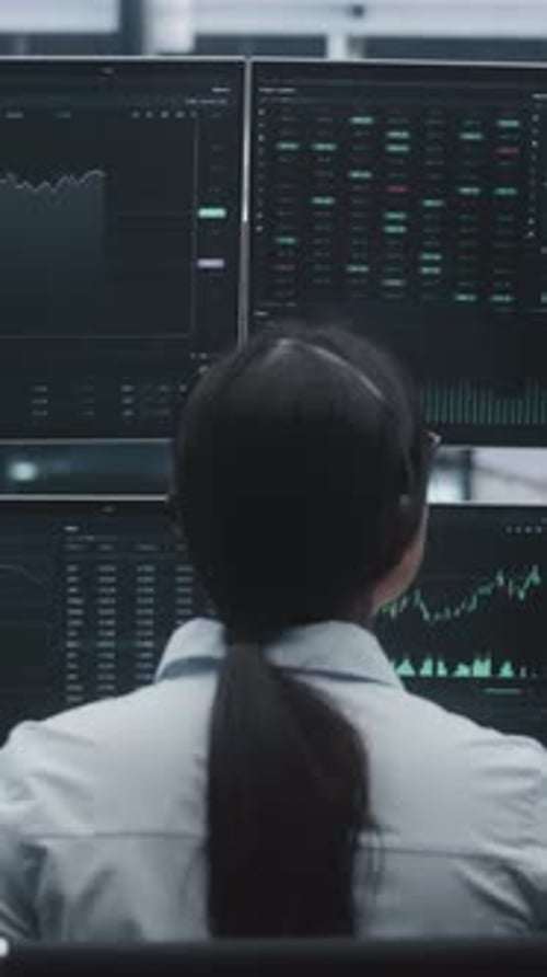 Female Trader With Long Hair Tied Back in Ponytail Works in Massive Innovative Digital Office