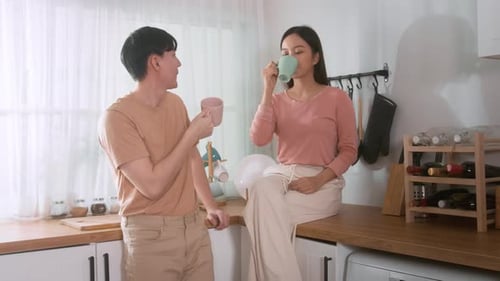 Young Couple Drinking Coffee Together in a Kitchen