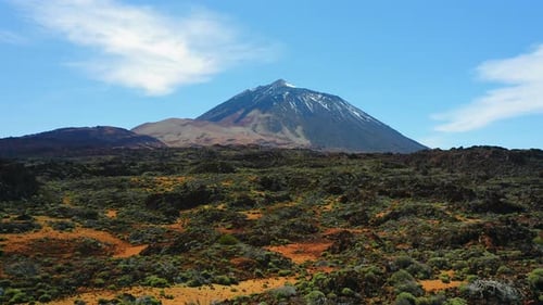 Aerial Flight Over Deserted Lava Fields in Teide Volcano Covered with Snow National Park