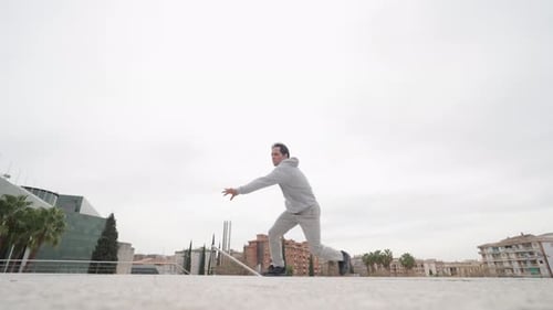 Man Does Gymnastics Flip in Urban Setting