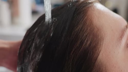 Water Rinsing Brown Hair in a Beauty Salon