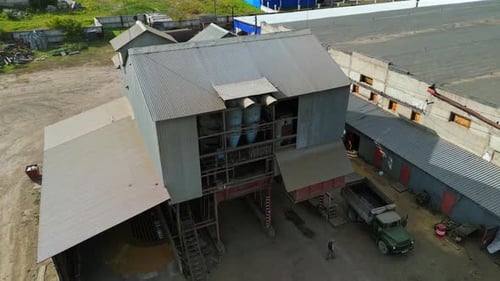 Small industrial building on grain processing factory. Agricultural farm in countryside.