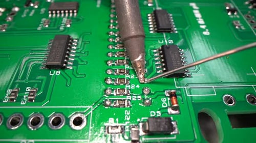 Technician Soldering Electronic Circuit Board