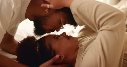 Loving Couple Embrace in Cozy Bedroom Setting