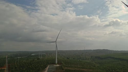 Drone view of wind farm generating alternative green energy. Wind turbines rotating at windmill park