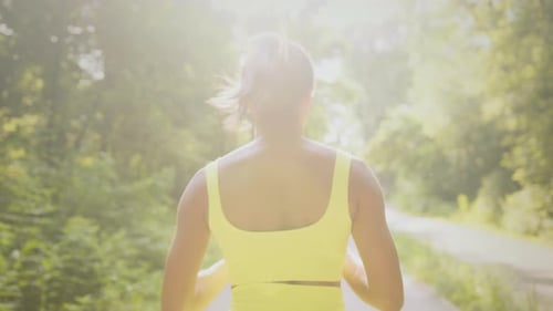 Young Black Woman Jogging in a Sunny Park for a Healthy Lifestyle
