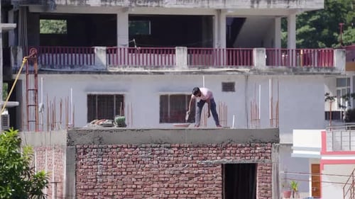 Indian man constructing a house