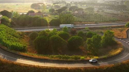 Aerial Drone Footage: Long Haul Semi Truck Driving on the Busy Highway in the Rural Region of Italy