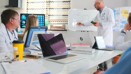 Pharma Representative Writing on Board During Hospital Seminar