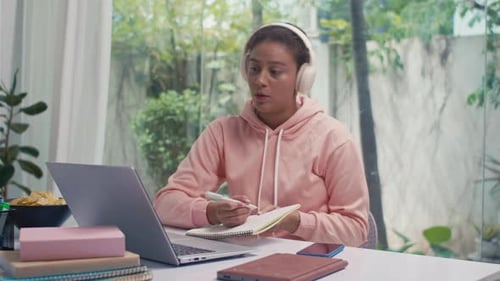 Young Adult Working on Laptop in Home Office