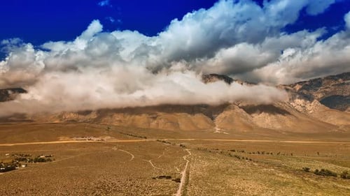 Desert Landscape with Mountains and Cloudy Skies