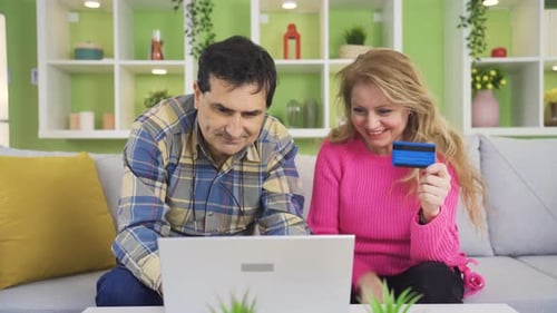 Couple Shopping Online with Laptop and Credit Card