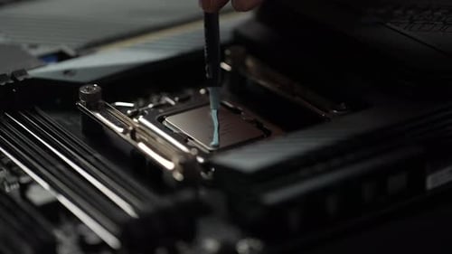 Closeup Hands of Unrecognizable Technician Male Applying Layer of Thermal Paste to Processor Before