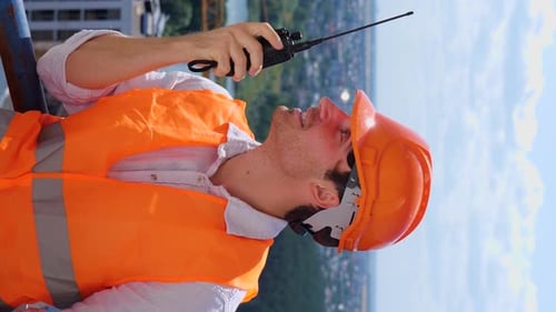 Construction Worker Communicating on High-Rise Building