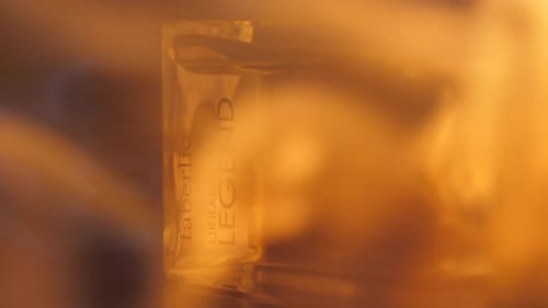 Perfume Bottle Spinning in Golden Light