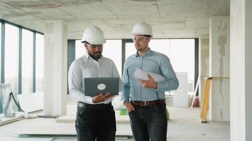 Indian Construction Engineer Giving Instructions to Colleague