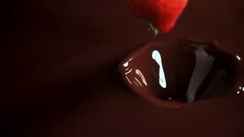 Strawberries Falling into Melted Chocolate