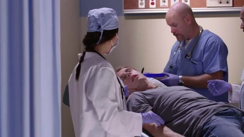 Medical Team Examining Patient with Head Injury in Hospital