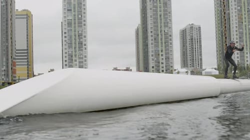 Wakeboarding Sportsman on Slider in Lake