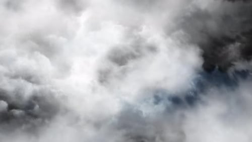 view entering thick white cumulonimbus clouds with lightning strikes