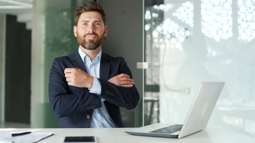 Bearded Man Smiling in Corporate Office Setting