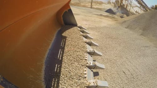 Interesting Point of View of loading and dumping gravels into a truck, Industrial at sand quarry. 4k