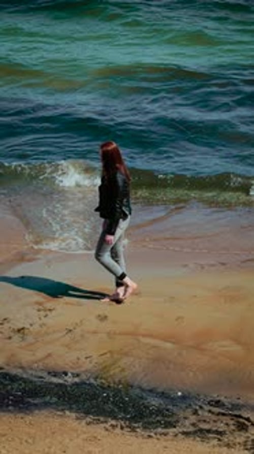 Woman Walking on Sandy Beach Near Sea Waves Vertical Orientation Female Strolling Barefoot Along