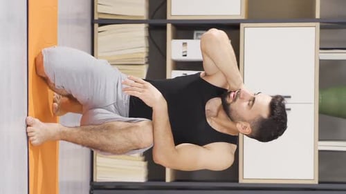 Man Working Out and Stretching on Yoga Mat
