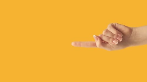 Hand Making a Pinky Promise on Yellow