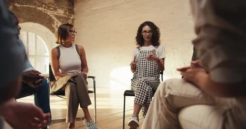 Diverse Group Meeting in Circle Applauds Speaker