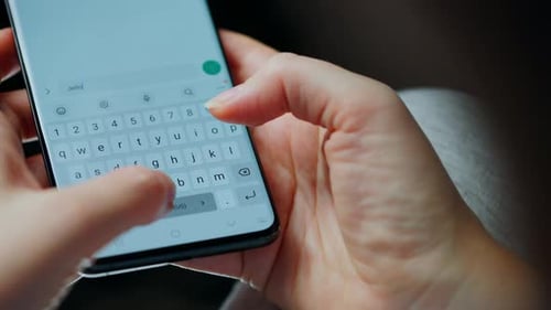 Female Hands Typing Text on Smartphone Closeup