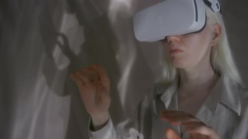Young Woman Using VR Headset for Virtual Interaction