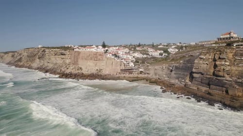 Long powerful waves washing on rocky coast and cliffs, Azenhas do Mar, Portugal.