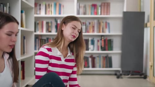 Woman Reads Book with Friends in Library