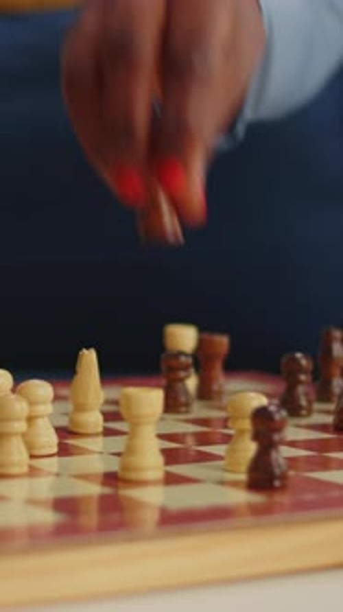 Vertical Video Close Up of Black Woman Moving Chess Pieces on Board