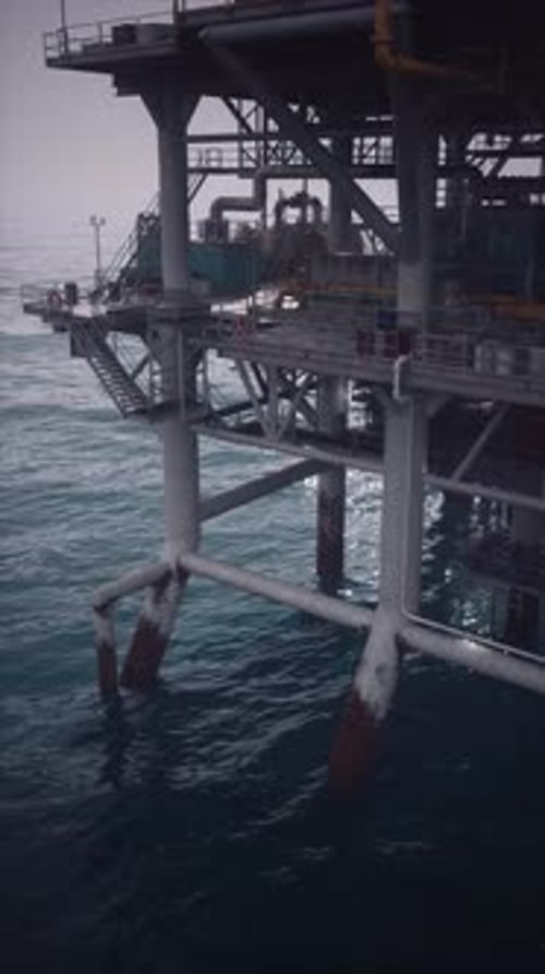 Oil Rig Standing Tall Over Waves As Workers Carry Out Important Tasks
