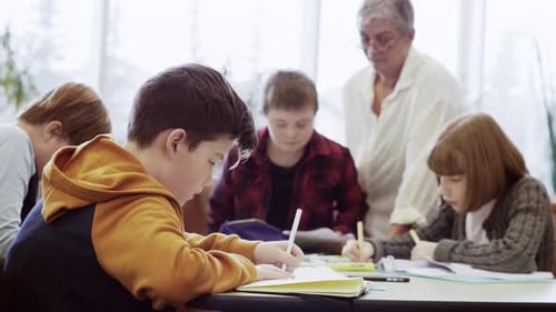 Focused junior high student dedicated to homework in school library